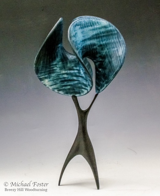Trefoil Waves-   Form- Figured Ash, dyed blue on black finish, 6” H x 7.5”D.  Stand;  Maple, dye, 7.125”H x 4”D, 13”H----SOLD