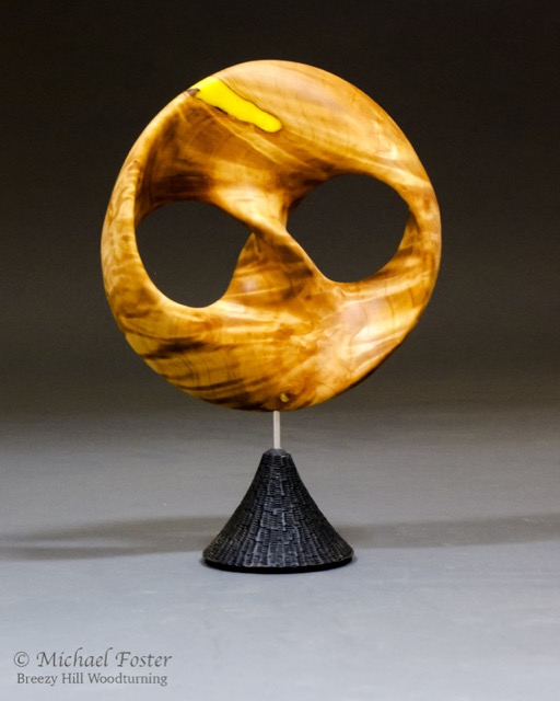 Infinite Loop-   A trefoil knot minimal surface.  The edges of the piece trace out a trefoil knot, and the wood joins those edges in a minimal surface.----AVAILABLE